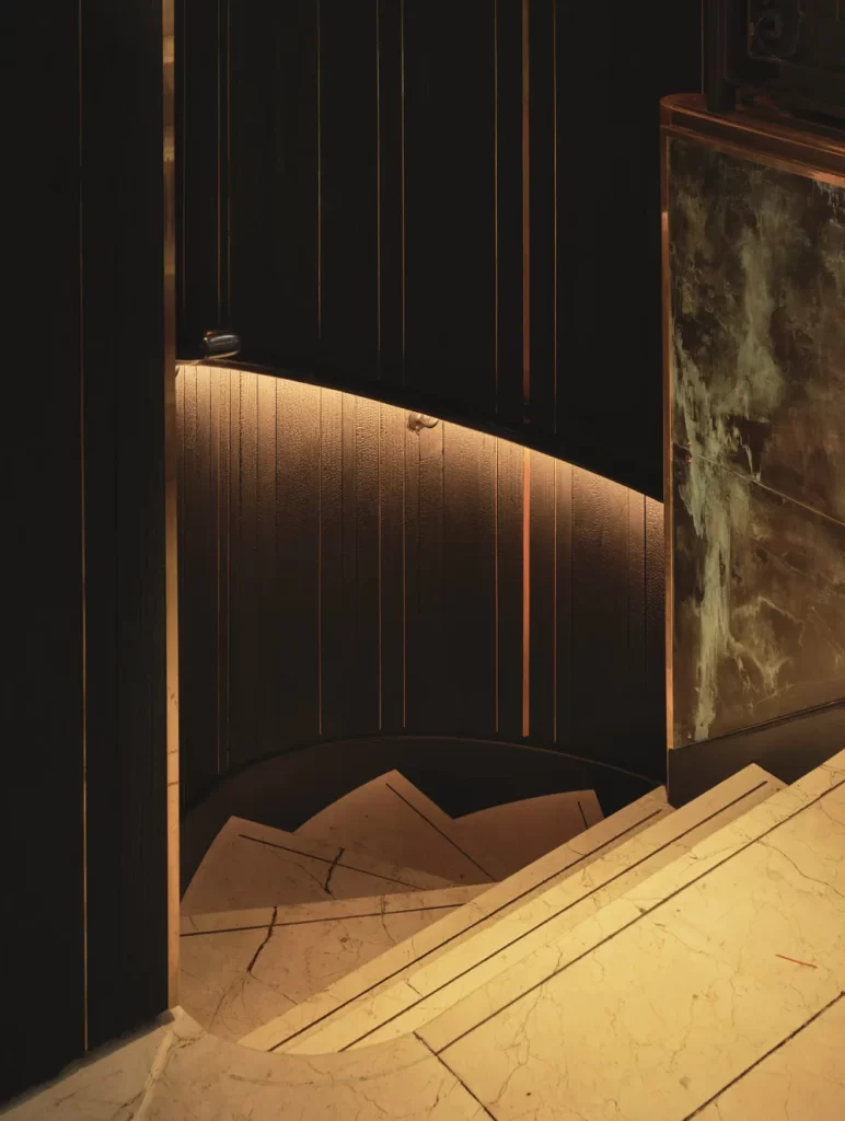 A staircase in a dark room illuminated by a spotlight.