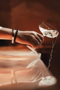 A woman pouring wine at a restaurant near Knightsbridge.